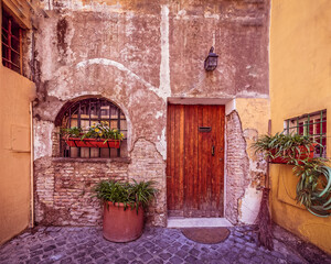 Fototapeta na wymiar Rome Italy, picturesque house front with natural wood door and window
