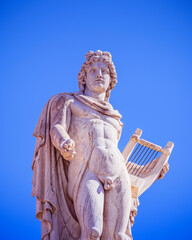 Athens Greece, Apollo ancient god of poetry and music marble statue on plain background