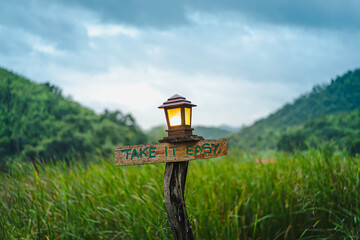 An old brown wooden sign with the words 