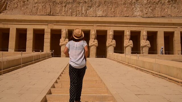 A young girl climbing the entrance stairs to Hatshepsut's Funerary Temple in Luxor, Egypt.