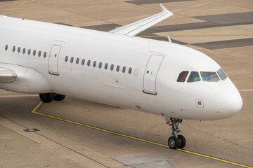 White airplane is departing on runway at Duesseldorf airport