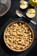 Cooking baking tart, with apple filling. Healthy wholemeal ,rustic traditional fruit tart.