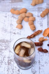 Tamarind juice, ripe tamarind fruit and seeds 