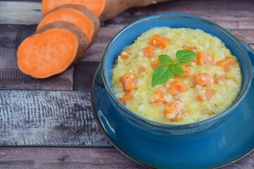 Sweet potato risotto with basil leaf in a bowl