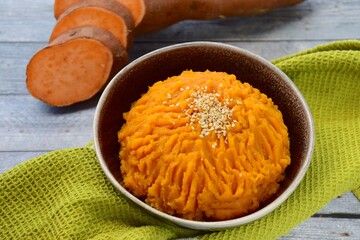 Bowl of mashed sweet potato garnish with sesame seeds 