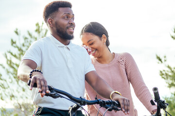 Obraz premium Vietnamese woman and african american man taking a bike for rent