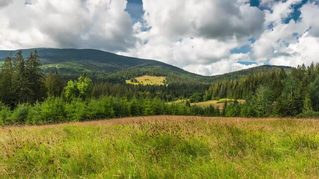 Time Lapse 4K Motion Footage of Babia Gora peak in National Park at Late Summer Season. Moving Clouds and Meadows. Outdoor Nature and Landscape.