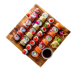 set of sushi roll with salmon, avocado, cream cheese, cucumber, rice, caviar, eel, tuna in wooden plate isolated on white background