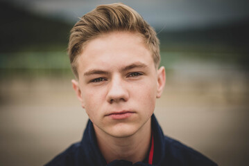 boy with stylish hairstyle outdoors. Looking at camera. Teenage boy © MartaKlos