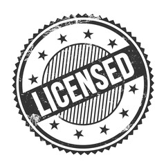 LICENSED text written on black grungy round stamp.