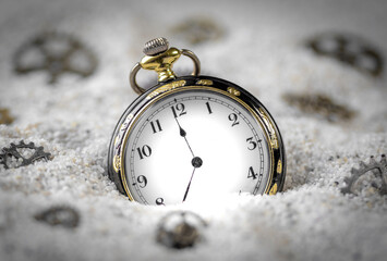 Macro photography of a old black and gold pocket watch on sand and Steampunk gears bronze made of...