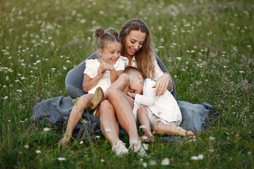 Fototapeta premium Family spends time on vacation in the village. Boy and girl playing in nature. People walk in the fresh air.
