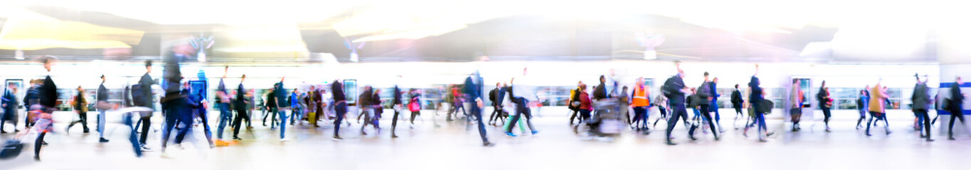 Lots of business people walking in big open space, transport station, airport etc. Blurred image,...
