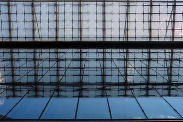 view from below on a glass facade of a modern corporate office building in the city center