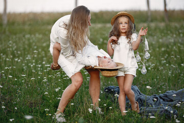 Family spends time on vacation in the village. Boy and girl playing in nature. People walk in the fresh air.