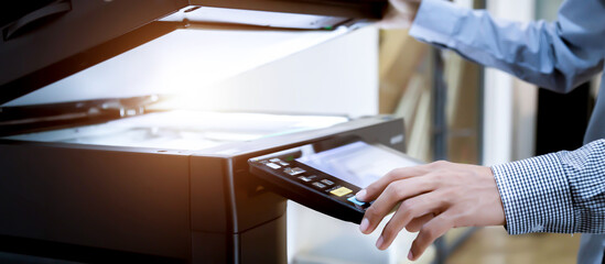 Business man Hand press button on panel of printer, printer scanner laser office copy machine...