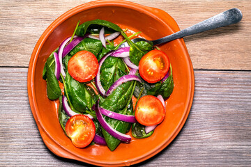 Tomato, basil and onion salad in olive oil