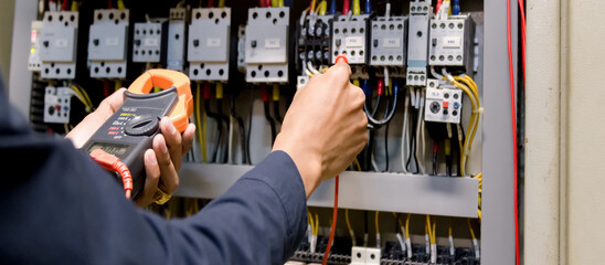 Electrician engineer work  tester measuring  voltage and current of power electric line in...