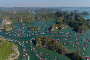 Floating Village on Ha Long Bay, Cat Ba Island, Vietnam, descending dragon bay Asia Aerial Drone...