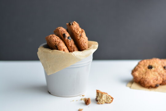 Gray jar with homemade oatmeat cookies on dark background.. Copy space.