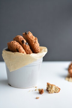 Gray jar with homemade oatmeat cookies on dark background. Copy space.