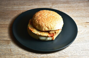 pork and bacon hamburger with cheese dressing ketchup on dish