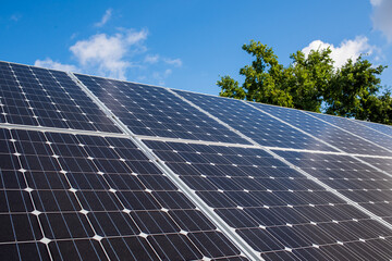solar panels on green hill in germany producing renewable energy to prevent climate change