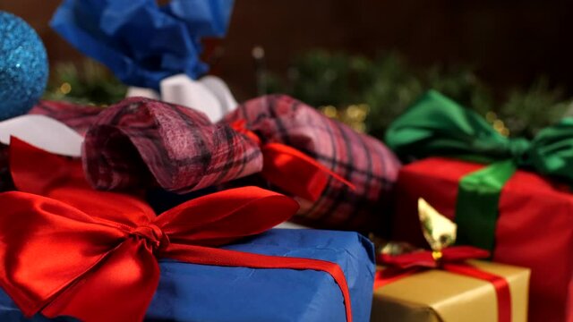 Christmas greeting card. Christmas gift boxes in a stack of presents. New year presents, festive and holiday shopping. Colorful holidays gift boxes and decoration on table. Home New Year's Eve comfort