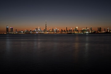 Fototapeta na wymiar Dubai slyline from Dubai Creek Harbour and Dubai canal to Downtown and Business Bay, United Arab Emirates