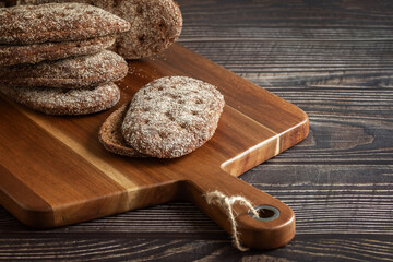 Rye bread on a wooden table. A crust of bread. Close-up. Cutting board. Diet.