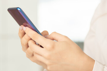 female hands uses the phone at the table, business concept