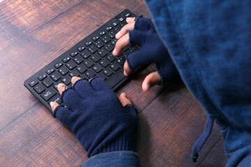 Fototapeta premium hacker hand stealing data from laptop top down 