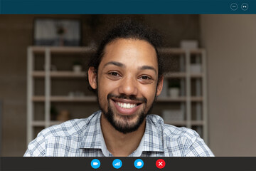 Head shot portrait screen view smiling African American man talking online, looking at camera,...