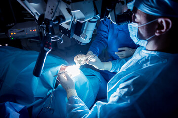 A team of surgeons performing brain surgery to remove a tumor.