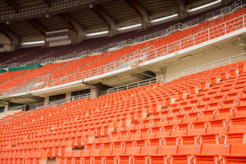 Orange spectator seats in a sports stadium.