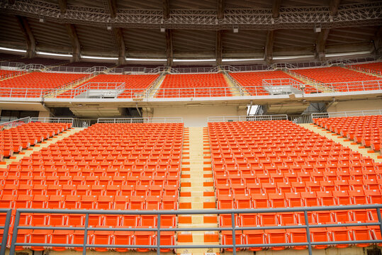 Orange Spectator Seats In A Sports Stadium.