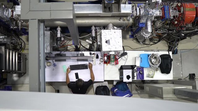 Group of engineers working  in the large factory