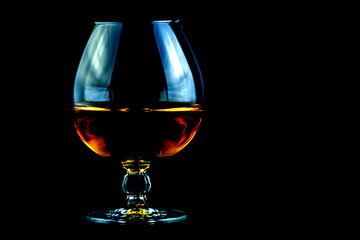 Large Brandy Glass with Brandy on a Black Background