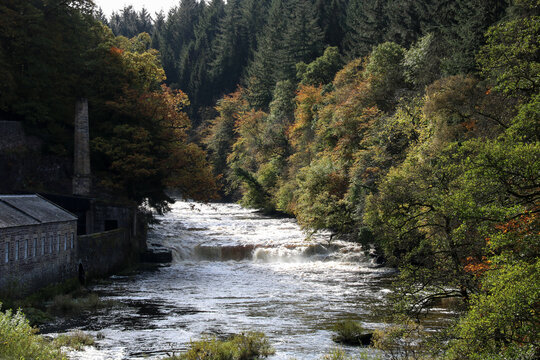 Old Disused Textile Mill and Rapid River at New Lanark Scotland in Autumn