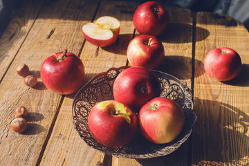 Cozy morning autumn composition fresh organic apples and nuts on rustic wooden table