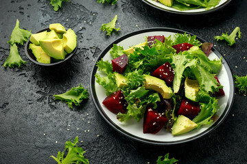 Vegetarian avocado and beet salad in plate. Healthy vegan food