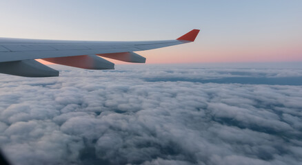 Fototapeta premium Wing of a airplane at sunrise at an altitude of 11 km.