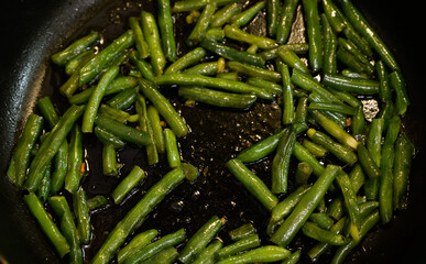 Fried beans in pods a pan. Seelctive focus.
