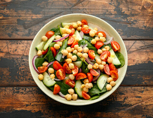 Chickpeas salad with tomato, cucumbers, red onion and greens. Dietary food. Vegan salad.