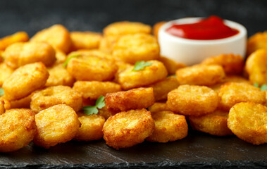 Mini hash browns, tater tots crispy golden potato bites served with jalapeno peppers dipped in ketchup