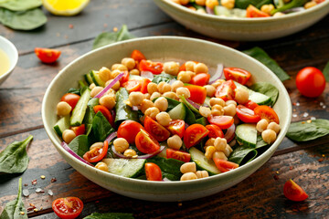 Chickpeas salad with tomato, cucumbers, red onion and greens. Dietary food. Vegan salad.