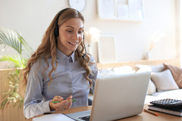 Freelance operator talking with headsets and consulting clients from home office.