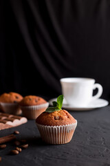 muffin and  cup of coffee  on a black background, 
breakfast
