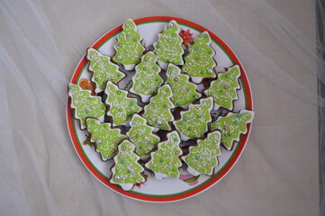 Christmas ginger cookies at green tree and many candy for background