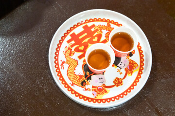 Tray with two disposable cup for Chinese wedding tea ceremony.   Chinese word on tray translated as...